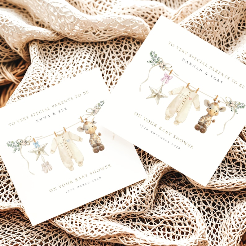 May include: Two baby shower invitations with watercolor illustrations. Each card features a clothesline with a onesie, star, and giraffe toy. Text reads "To Very Special Parents To Be" and the names of the parents, plus the baby shower date.