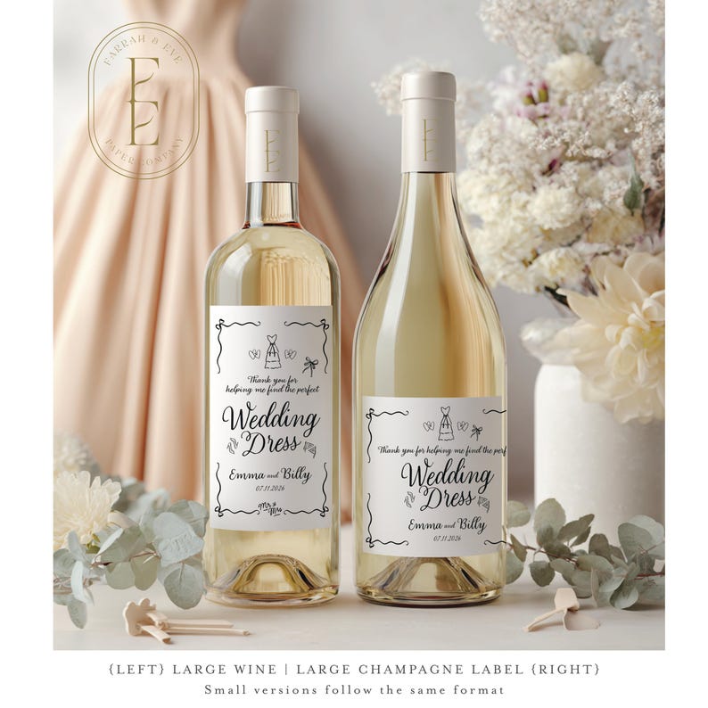May include: Two glass wine bottles featuring white rectangular labels with black decorative borders and text that reads Thank you for helping me find the perfect Wedding Dress, Emma and Billy, and the date 07.11.2026, with small line art illustrations.