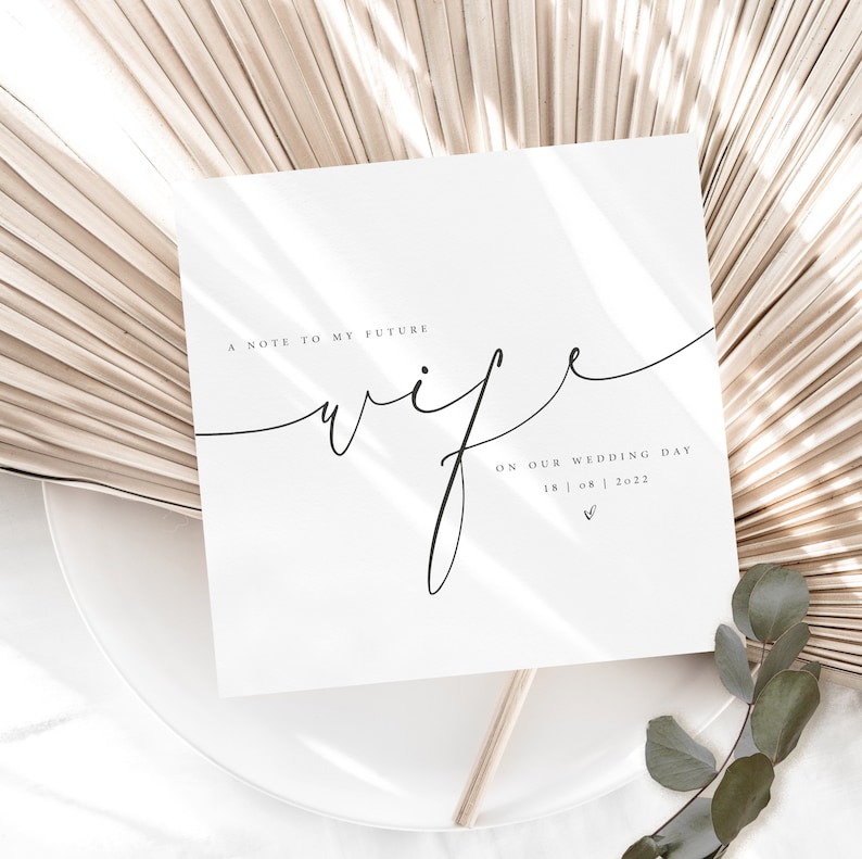 May include: A white card with the text "A note to my future wife on our wedding day 18 | 08 | 2022" written in black calligraphy.