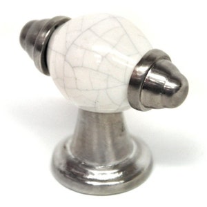 May include: White ceramic cabinet knob with a crackled finish and a silver metal base.