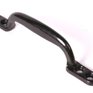 May include: A black, curved handle with two mounting plates at each end, each with two screw holes. The handle is made of a glossy, solid material, probably metal, and is designed for pulling or lifting.