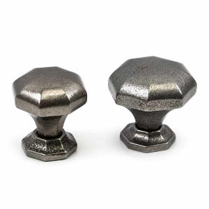 May include: Two cabinet knobs with a dark, weathered metallic finish. Each knob features an octagonal top surface and a matching octagonal base, connected by a tapered, faceted stem. The metal has a textured, matte appearance throughout.
