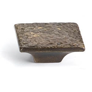 May include: Square cabinet knob with a textured, hammered bronze finish. The knob has a square base and a slightly raised top.