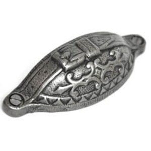 May include: A silver-toned metal cabinet pull with an ornate design. The pull is shaped like an oval with a raised centre section. The design features a stylised floral pattern and a geometric border.