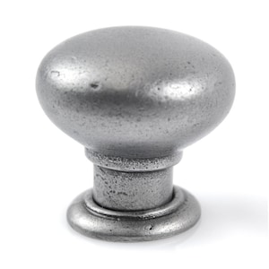 May include: A silver-toned metal knob with a rounded top and a slightly raised base. The knob has a textured finish.
