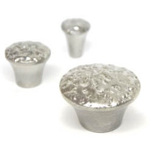 May include: Three silver metal cabinet knobs with a textured, hammered finish. The knobs are different sizes.