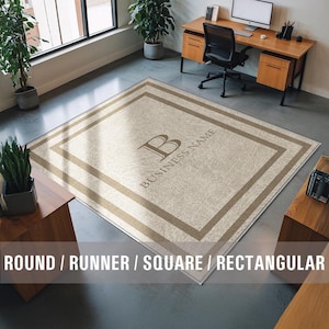 May include: A beige square floor mat with a brown border and the text "BUSINESS NAME" and the letter "B" in the center.