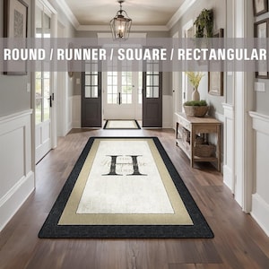 May include: A rectangular doormat with a black border and a beige inner border. The doormat has the text "The Hampshire Residence" in black lettering on a white background.