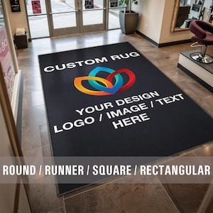 May include: A black custom rug with the text "CUSTOM RUG" and "YOUR DESIGN LOGO / IMAGE / TEXT HERE" in white. The rug has a colorful logo in the center. The text "ROUND / RUNNER / SQUARE / RECTANGULAR" is at the bottom of the image.