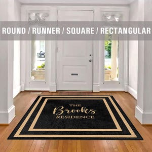 May include: Black doormat with a tan border and the text "The Brooks Residence" in gold lettering.