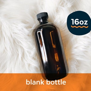 May include: A 16oz amber glass bottle with a black lid. The bottle is empty and sitting on a white fluffy surface.  The text "16oz" is visible in a blue circle with a wavy orange line.
