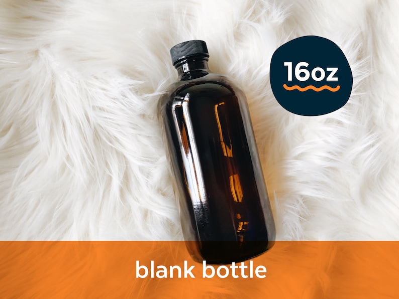 May include: A 16oz amber glass bottle with a black lid. The bottle is empty and sitting on a white fluffy surface.  The text "16oz" is visible in a blue circle with a wavy orange line.