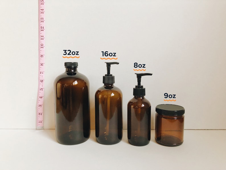 May include: Four amber glass bottles with black pump tops and a smaller amber glass jar with a black lid. The bottles are labeled 32oz, 16oz, and 8oz. The jar is labeled 9oz.