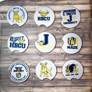 May include: Nine round white coasters with various designs featuring a yellow bull, the letters JCSU, the text "Respect My HBCU", and the text "Heavy on the History".