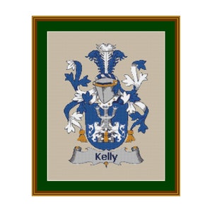 May include: A framed cross-stitch design featuring a blue and gold coat of arms with the name "Kelly" on a banner below.
