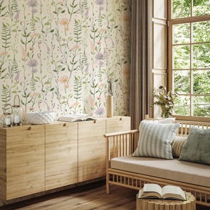 May include: A room with floral wallpaper featuring pink, purple, and green flowers and foliage. A light wood cabinet, a sofa with cushions, and a small wooden table with a book are in the room. A large window with natural light is on the right.
