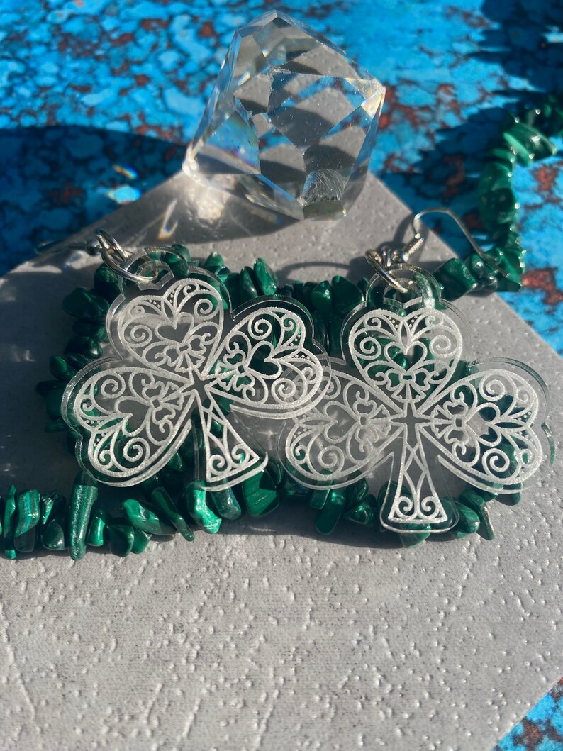 Transform your collection with our lucky St. Patrick's Day heart shamrock earrings.  These intricately detailed earrings displayed in the picture are engraved on clear acrylic.