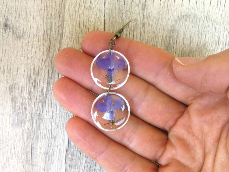 Closed bronze-colored open monachella handmade In transparent resin Earrings with pressed blue flowers Height 6 cm