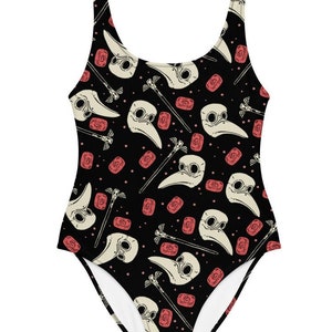 May include: Black one-piece swimsuit with a repeating pattern of white plague doctor masks, red roses, and black wands.