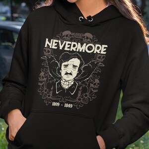 May include: Black hoodie with a graphic print of Edgar Allan Poe, two ravens, and the text "NEVERMORE" with the words "MURDER APPAREL" above the text. The graphic also includes the dates "1809 - 1849".