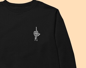 May include: Black long-sleeved sweatshirt with a white embroidered skeleton hand giving the middle finger.