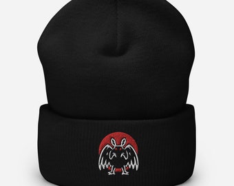 May include: Black beanie with a red and white embroidered bat design. The bat is in a circle with a red background.