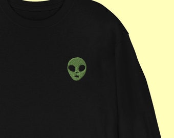 May include: Black long-sleeved sweatshirt with a green alien face embroidered on the front.