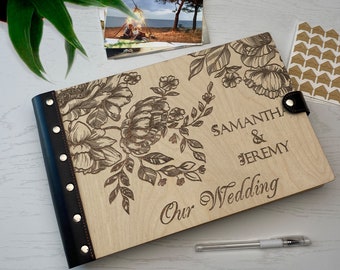 May include: A wooden photo album with a floral design and a black leather spine. The album is personalized with the names "Samantha & Jeremy" and the text "Our Wedding".