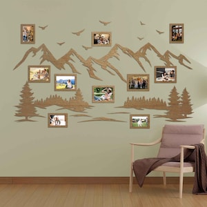 May include: A wooden wall decor featuring a mountain range silhouette with a forest scene and 10 photo frames. The frames are arranged in a staggered pattern and are perfect for displaying family photos.