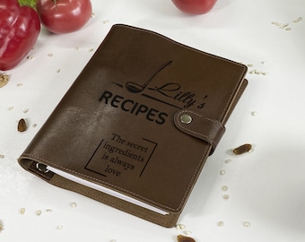 May include: Brown leather recipe book with a gold clasp and the text "Lilly's Recipes" and "The secret ingredient is always love".