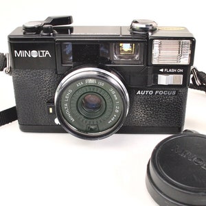 Minolta Hi-Matic AF2 35mm Film Camera + Minolta 38mm f2.8 Lens + Neck Strap + Lens Viewfinder Cap + New Batteries - Film Tested