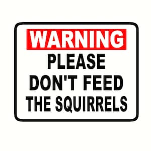 May include: A black and white sign with the text "WARNING PLEASE DON'T FEED THE SQUIRRELS". The word "WARNING" is in red.