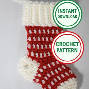 May include: A crocheted Christmas stocking in red and white. The stocking features a white cuff and toe, with a red body adorned with white dotted patterns. The image includes text that reads "Instant Download" and "Crochet Pattern".