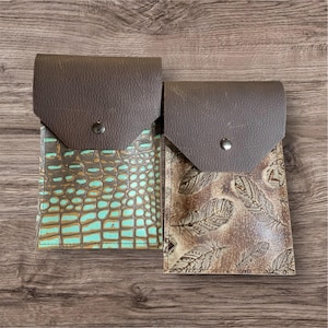 Leather saddle cell phone holder, back cinch cell phone holder, saddle phone pouch.