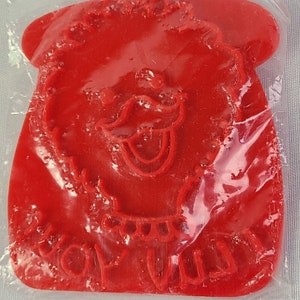 May include: Red plastic cookie cutter shaped like Big Bird from Sesame Street. The cutter features Big Bird's face with a large beak, eyes, and a tongue sticking out. The text "Big Bird" is written below the face.