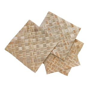 May include: Four woven placemats made of natural materials, with a light brown color and a diamond pattern.