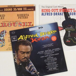 May include: Three vintage vinyl records featuring the musical productions of Alfred Drake. The first record is a 1962 recording of the musical Carousel, featuring Alfred Drake and Roberta Peters. The second record is a recording of the musical Sing Out, Sweet Land! featuring Alfred Drake and Burl Ives. The third record is a recording of the musical Kean, featuring Alfred Drake.