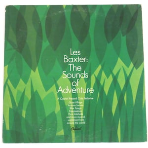 May include: A green vinyl record album cover with the title "Les Baxter: The Sounds of Adventure" and a Capitol Records Club Exclusive label. The cover features a stylized design of green leaves.