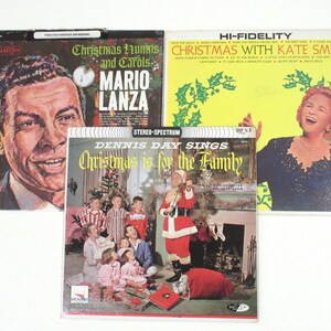 May include: Three vintage vinyl records with Christmas themes. The first record features a portrait of Mario Lanza and the text "Christmas Hymns and Carols". The second record features a family gathered around a Christmas tree and the text "Dennis Day Sings Christmas is for the Family". The third record features a portrait of Kate Smith and the text "Christmas with Kate Smith".