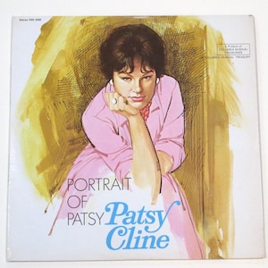 May include: A vintage vinyl record album cover featuring a portrait of Patsy Cline. The cover is white with a yellow and orange background. The title "Portrait of Patsy Cline" is printed in blue and black text. The album is a product of Columbia Musical Treasuries.