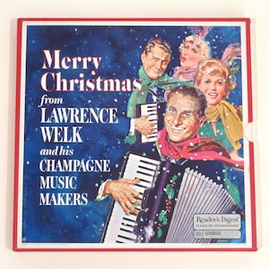 May include: A vintage record album cover featuring Lawrence Welk and his Champagne Music Makers. The cover is blue with snowflakes and features a group of people playing musical instruments. The text on the cover reads "Merry Christmas from Lawrence Welk and his Champagne Music Makers".