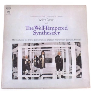 May include: A vintage vinyl record album cover featuring a black and white photo of four men in period clothing standing in a white room with a grid pattern. The album title is "The Well-Tempered Synthesizer" by Walter Carlos. The album cover also includes the text "More virtuoso electronic performances of Bach, Monteverdi, Scarlatti, Handel."