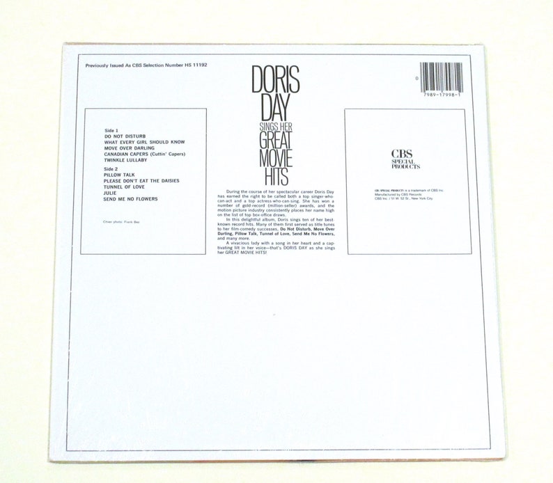 May include: White vinyl record album cover with a black and white photo of Doris Day. The album title is "Doris Day Sings Her Great Movie Hits". The album cover lists the songs on each side of the record.