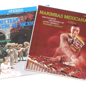 May include: Two vintage vinyl records. The record on the left is titled "The Hottest Mariachi in Mexico" with a picture of a mariachi band. The record on the right is titled "Marimbas Mexicanas" with a picture of a man playing a marimba.