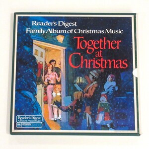 May include: A vintage Reader's Digest record album cover featuring a festive illustration of a family singing Christmas carols outside a home. The album title is "Together at Christmas".