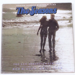May include: Album cover art for "The Seasons" by The San Sebastian Strings featuring Rod McKuen and Anita Kerr. The cover features a silhouette of a couple walking on a beach.