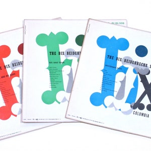 May include: Three vintage vinyl records with the title "The Bix Beiderbecke Story" and the text "Volume 3 GL 509". The records feature a large, stylized "Bix" in different colors: red, green, and blue.
