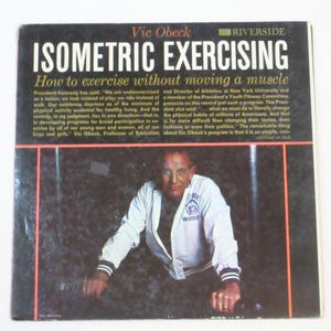 May include: A vintage book cover featuring Vic Obeck and the title "Isometric Exercising." The cover is predominantly black with white text, including the subtitle "How to exercise without moving a muscle." A photo of Vic Obeck is at the bottom.