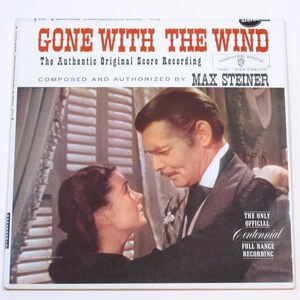 May include: A vintage vinyl record album cover for "Gone With The Wind." The cover features a romantic image of two people looking at each other. The title is in red, and the composer is Max Steiner. The album is a Centennial Full Range Recording.