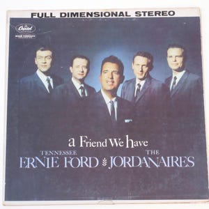 May include: A black and white album cover with a group of five men in suits. The album title is "a Friend We Have" and the artist is "Tennessee Ernie Ford & The Jordanaires".